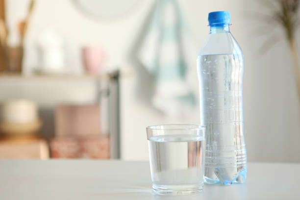 istock Clear water in a glass and bottle on the table 1269919268
