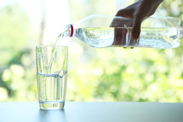istock Clear water in a glass and bottle on the table 1269919275