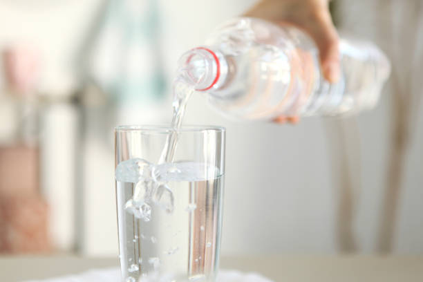 istock Clear water in a glass and bottle on the table 1269919298