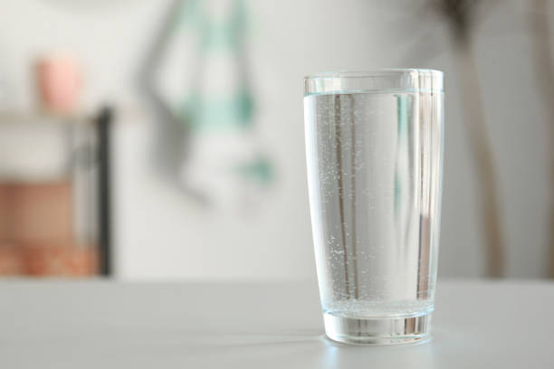 istock Clear water in a glass and bottle on the table 1269919310