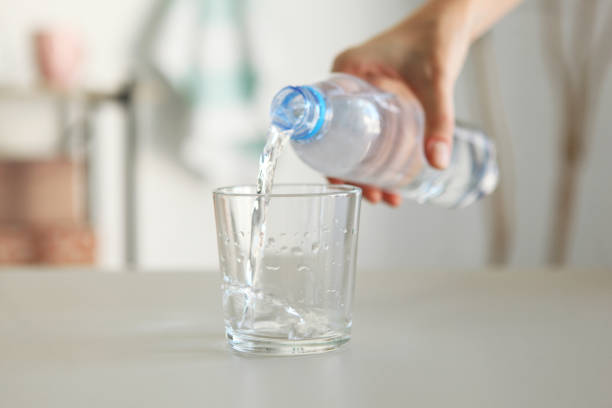 istock Clear water in a glass and bottle on the table 1269919314