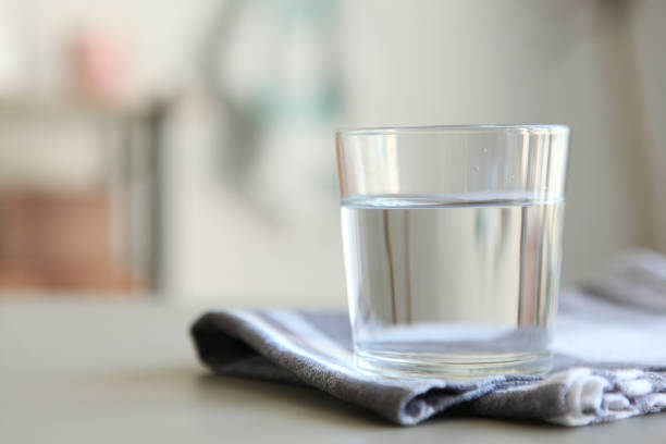 istock Clear water in a glass and bottle on the table 1269919345