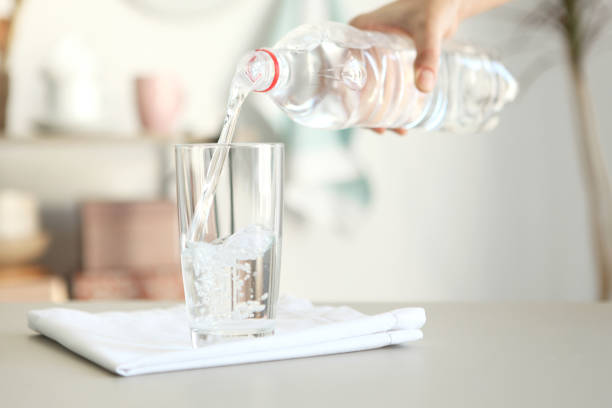 istock Clear water in a glass and bottle on the table 1269919358