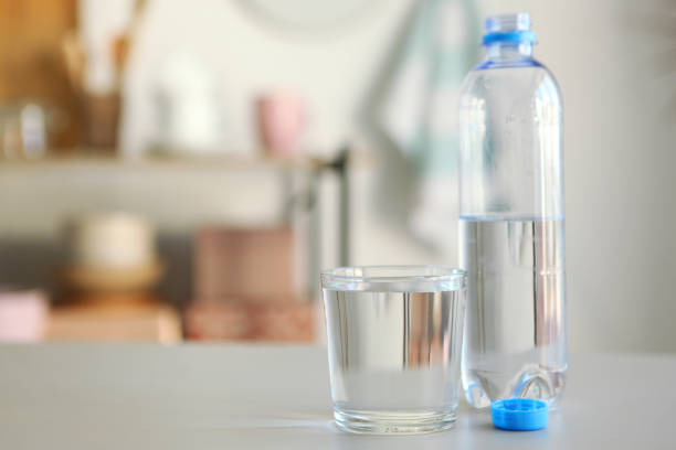 istock Clear water in a glass and bottle on the table 1269919390