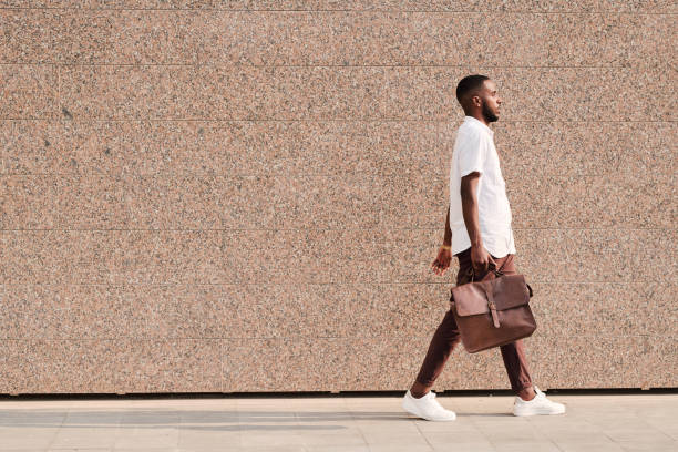 istock African-American businessman walking with briefcase 1269923098