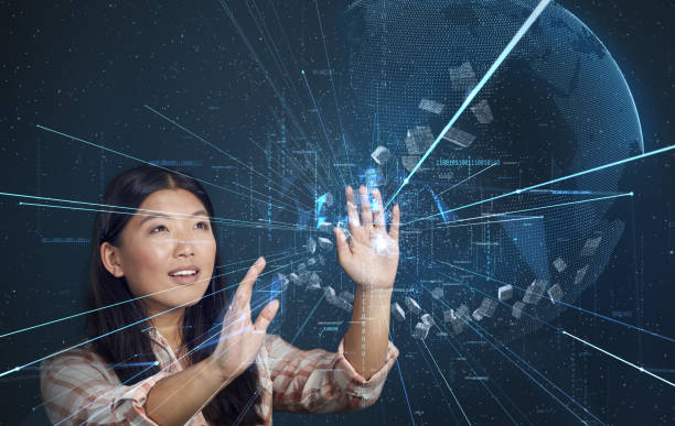 istock Asian woman exploring virtual reality. Reaching for scattered particles 1269923375