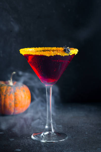 istock Halloween coctail black widow with red drinks in glass on dark background 1269924914