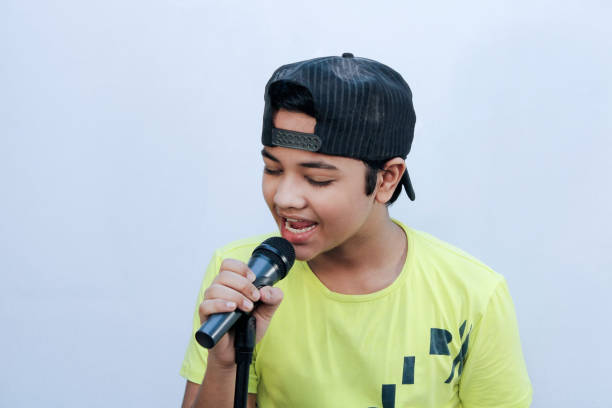 istock A boy trying for sing song and hold dynamic mic in hand and shouting 1269925152