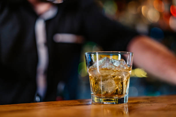 istock Glass of whiskey on bar counter 1269926436