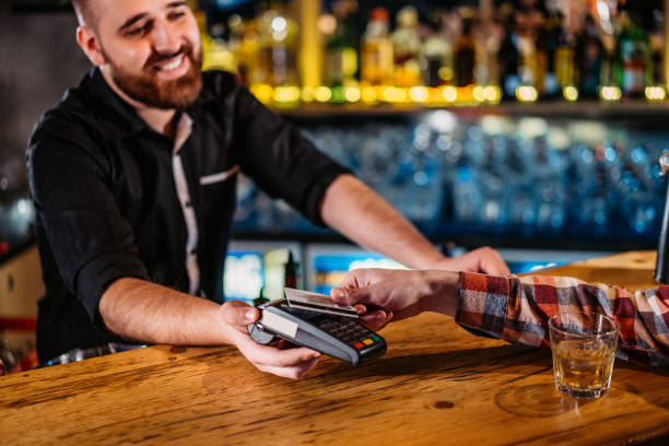 istock Man paying with credit card in bar 1269926829