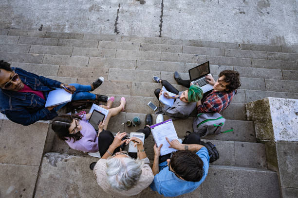 istock Professor lecturing to students on stairs 1269929268