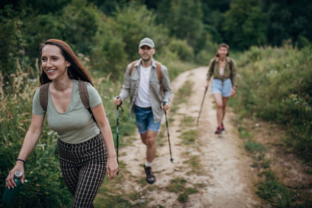istock Three friends hiking together on forest trail 1269930272