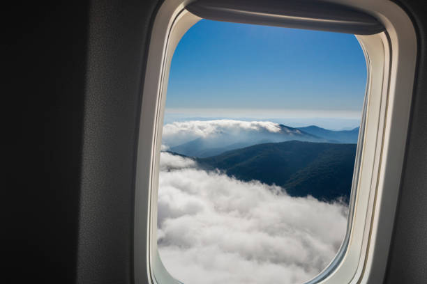 istock Airplane window overlooking the beautiful clouds and the earth. 1269930382