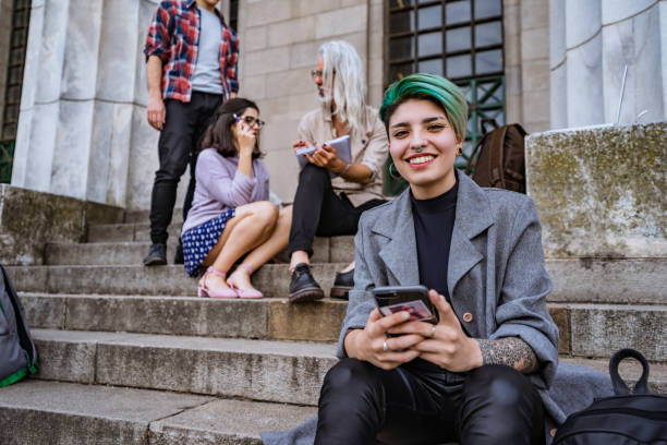 istock Young woman using phone on stairs 1269930512