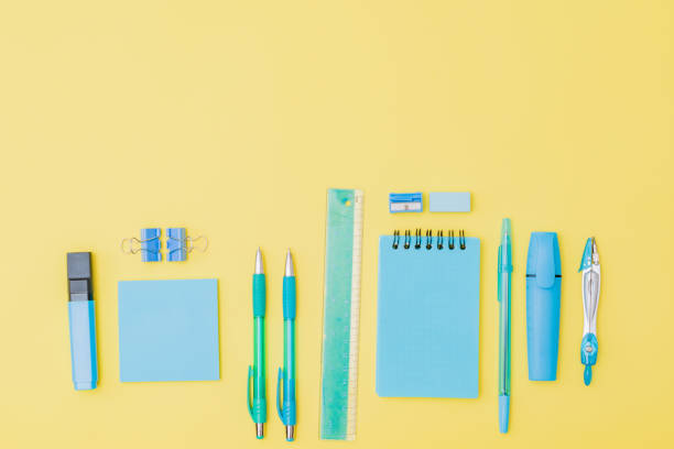 istock Flat lay border with school supplies on a yellow background 1269931394