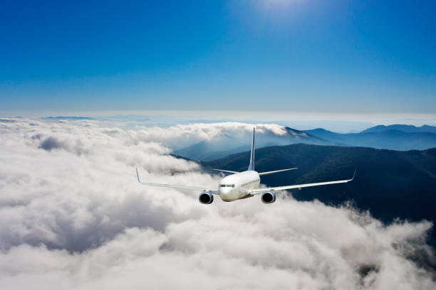 Passenger jet airplane flying above clouds. Passenger jet airplane flying above clouds. upward mobility stock pictures, royalty-free photos & images