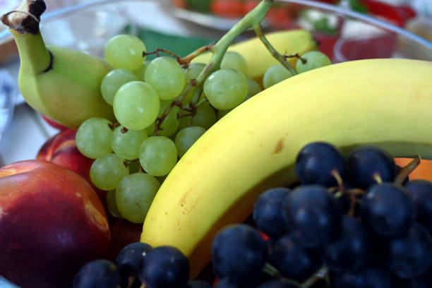 istock fruit bowl with bananas, grapes, peaches, nectarine and apricot 1269931714