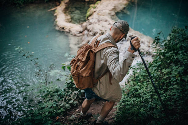 istock One young man hiking in deep forest 1269931883