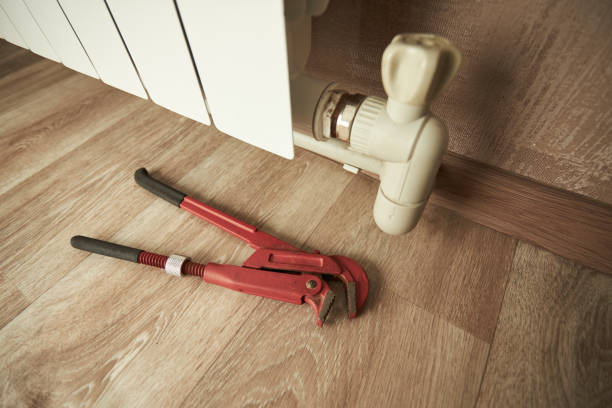 istock central heating system repairing indoors. water aluminum radiator close up. work tools for maintenance. diy concept 1269937381