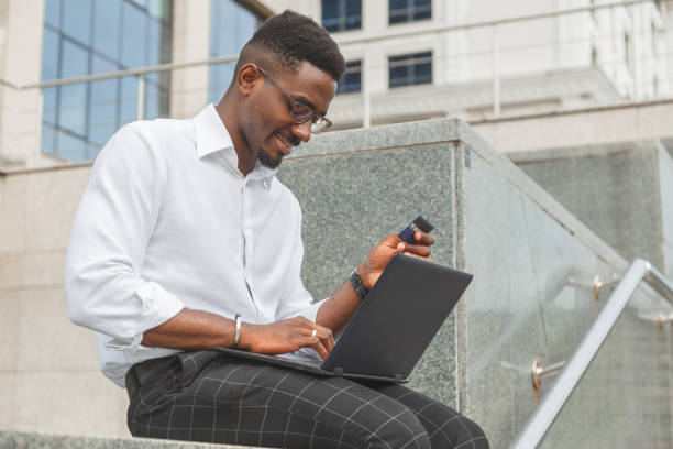 istock Businessman using credit card and laptop at home office 1269937498