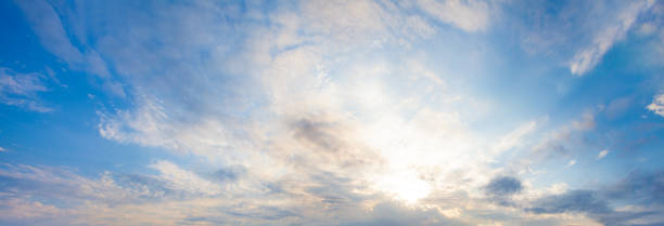 istock Blue sky clouds background. Beautiful landscape with clouds and orange sun on skysky 1269937748