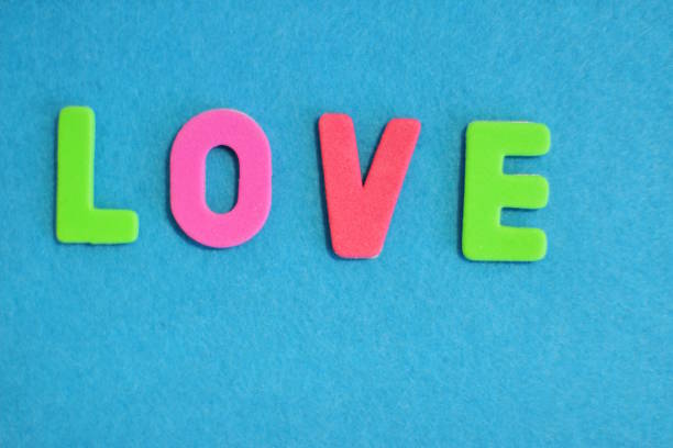 istock Love is, word on blue texture background 1269940115