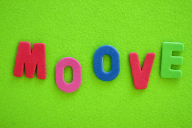 istock Move lettering, colorful letters on green textured background, copy space 1269940166