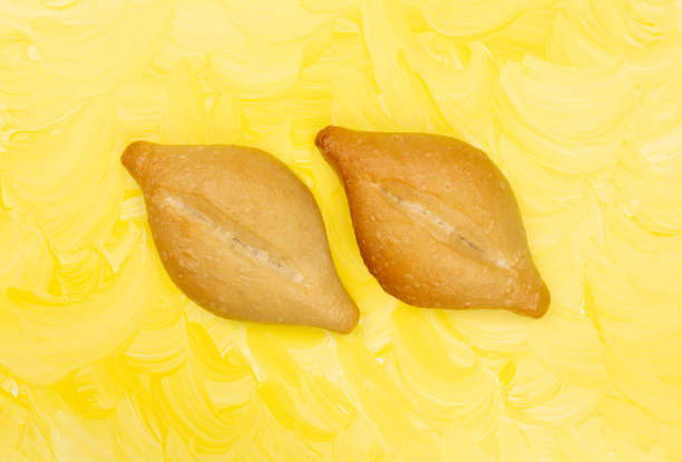 istock Two bolillo bread rolls on a yellow painted background 1269948303