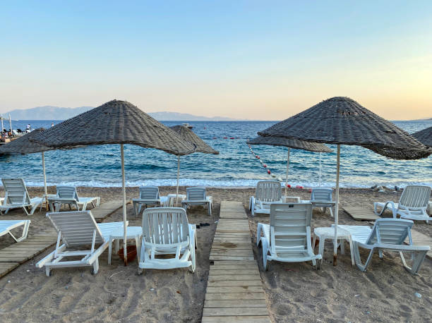istock empty beach and sunbeds in the evening 1269949344