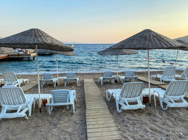 istock empty beach and sunbeds in the evening 1269949350