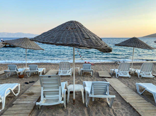 istock empty beach and sunbeds in the evening 1269949354