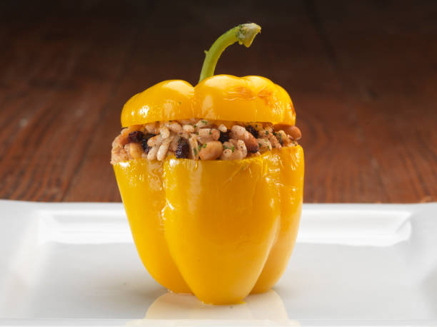 Stuffed yellow bell peppers on small plate on table