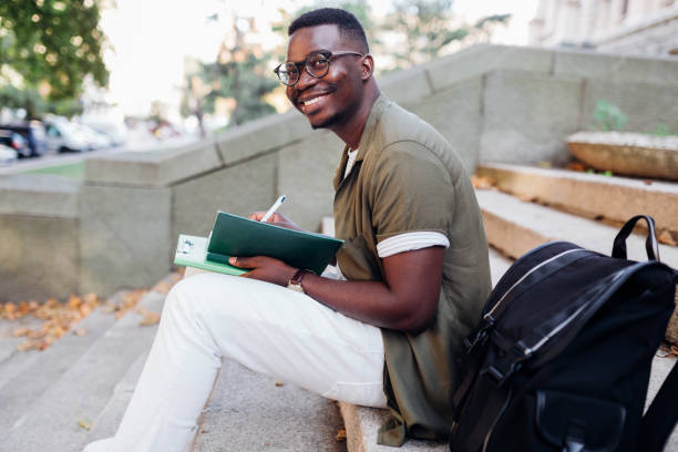 istock Young African American male student sitting on a staircase 1269950683