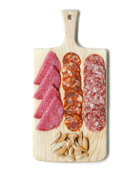 istock Assorted Iberian pork cured sausages on cutting board isolated on white background. Top view 1269951377