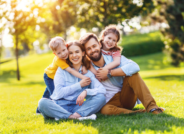 istock Delighted family hugging on lawn 1269951462
