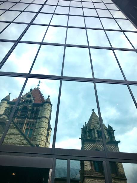 istock Old Stone Church Reflected in Modern Glass Tower 1269954100