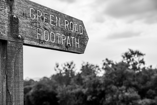 Wooden signpost for the Green Road public footpath in an area of outstanding beauty near Lackan Bog, County Down, Northern Ireland.  Black and white.