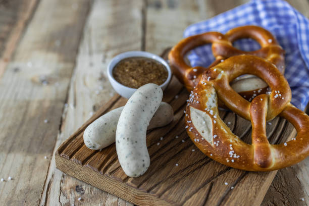 Beer Fest food. Bavarian meal . White sausages, brezel and sweet mustard on wooden table Beer Fest food. Bavarian meal . White sausages, brezel and sweet mustard on wooden table weisswurst photos stock pictures, royalty-free photos & images