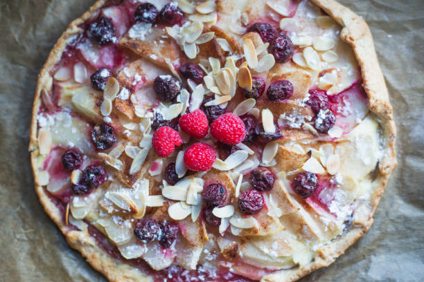 istock Galette with pear, berries, almonds on baking paper 1269957502