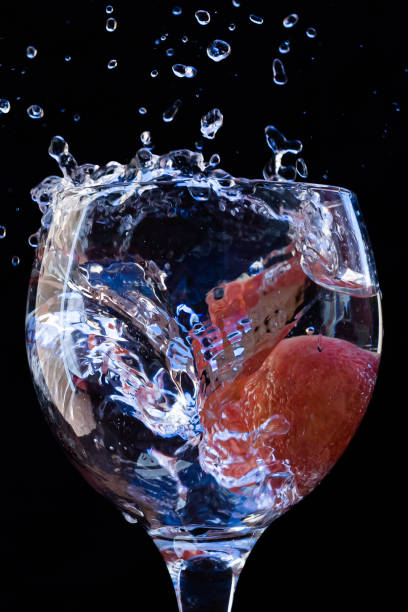 Effect of dropping a fruit into a glass cup with water