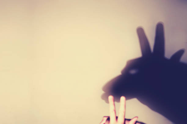 istock Play shadows from hands on the wall - silhouette goat. Selective focus on hand shadows 1269959817