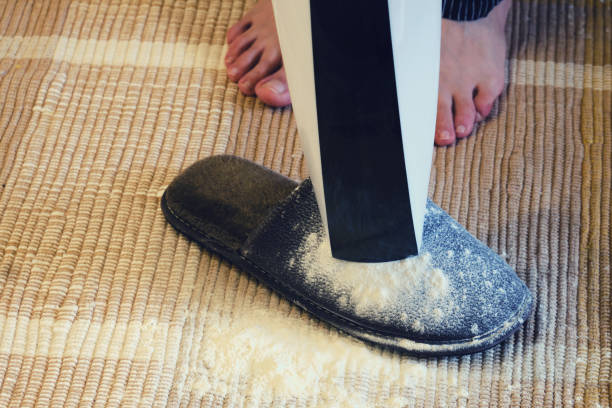 istock A man cleans the floor with a handheld vacuum cleaner 1269959982