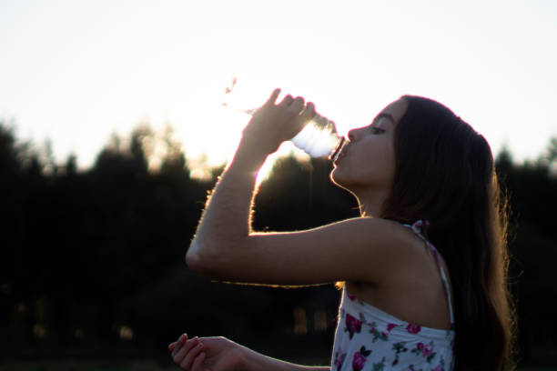 istock girl drinking water at sunset 1269960003