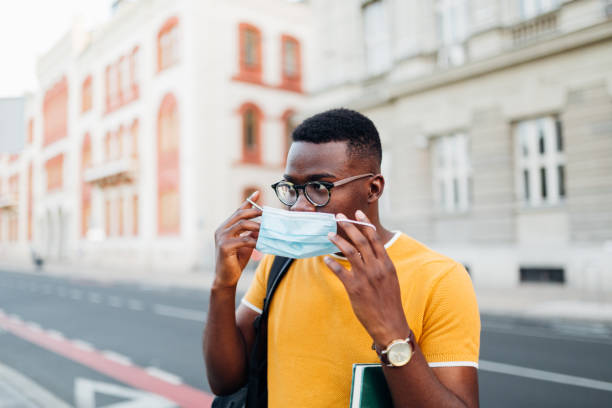 istock African American student putting on his protective face mask 1269964263
