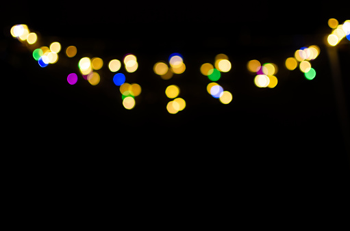 Bokeh of colored lights on a black background, overlay ideal for editing. Overlay, layer, background.