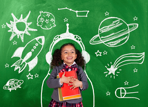African-American schoolgirl dreaming is to be an astronaut