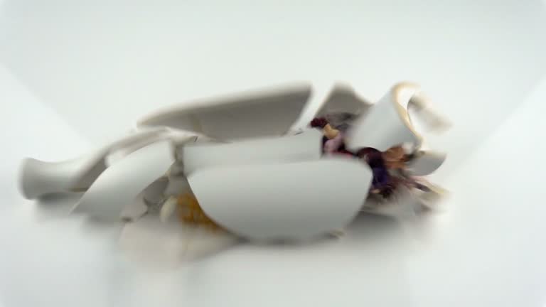 The concept of destruction. Falling and breaking decorative vase in slow motion.