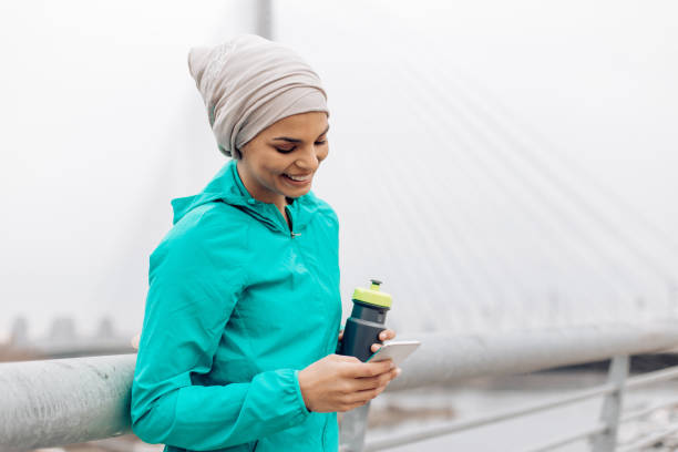 istock Charismatic arabian holding the phone 1269965314