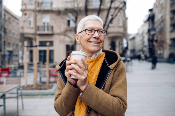 istock Warm coffee and older lady 1269965489