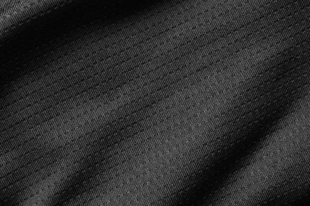 Black sport cloth fabric football shirt jersey texture close up Black sport cloth fabric football shirt jersey texture close up polyester photos stock pictures, royalty-free photos & images